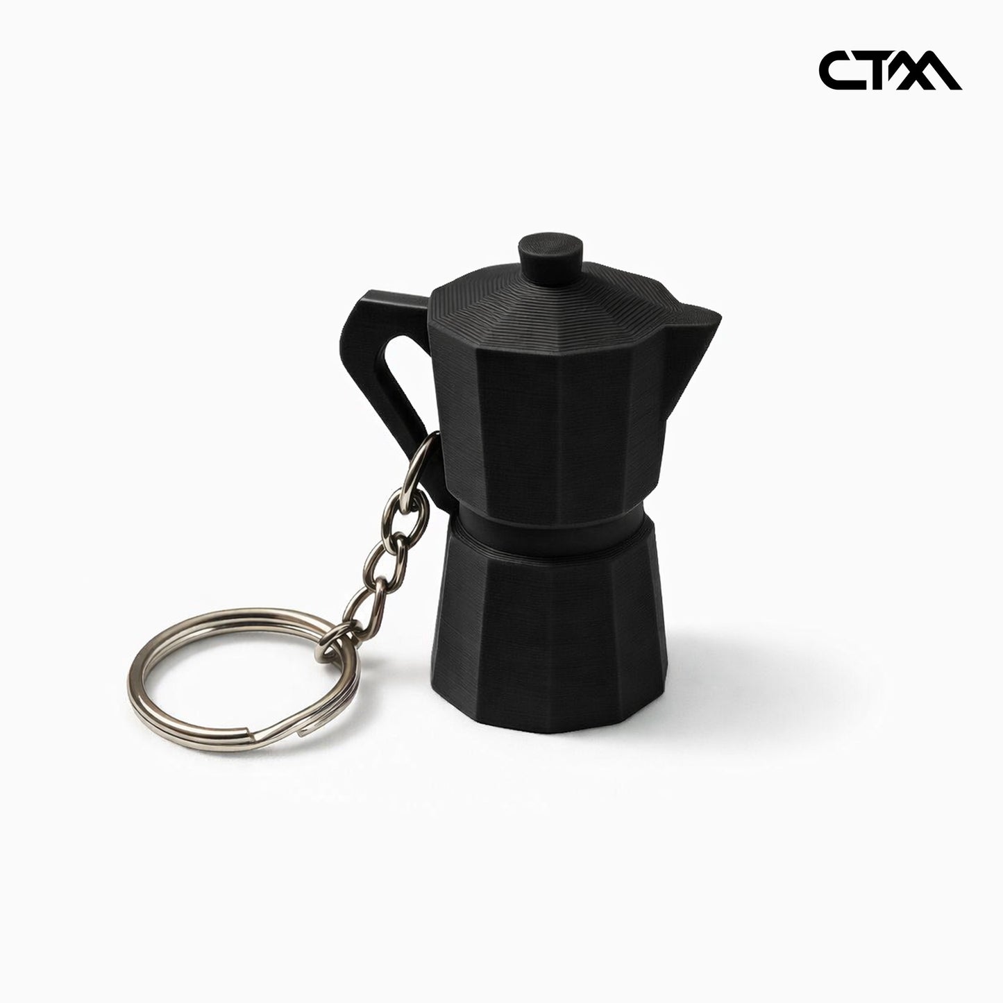 Black coffee pot-shaped keychain on a white background